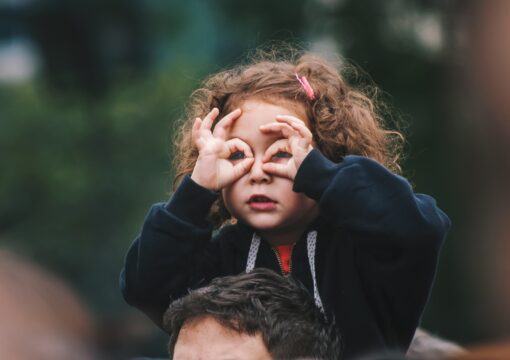 Small girl on her Dad's shoulders