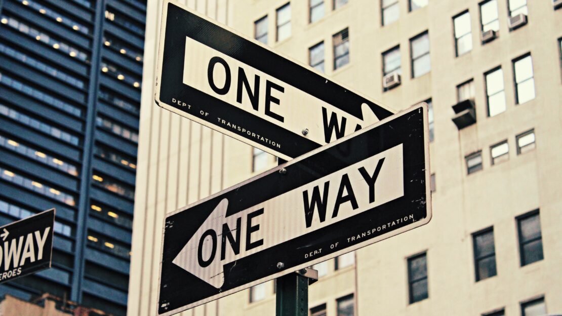 Street signs pointing in opposite directions