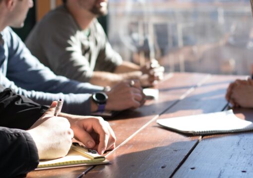 People discussing and taking notes