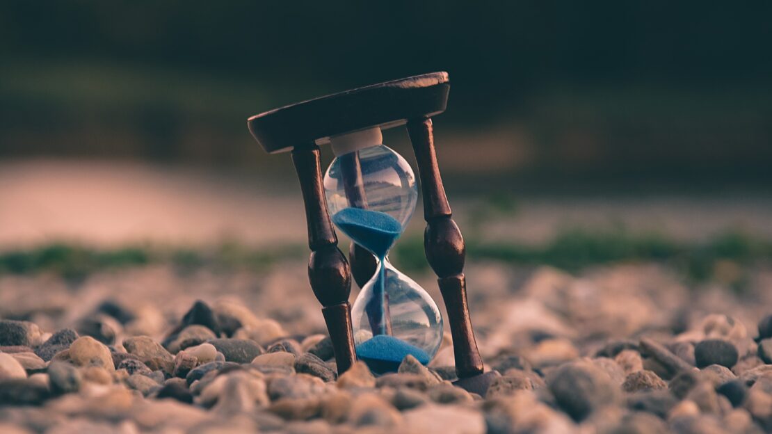 Hourglass on a pebbly beach