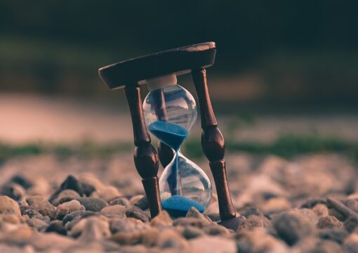 Hourglass on a pebbly beach